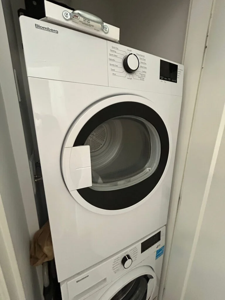 Stacked Blomberg dryer serviced in a New York apartment